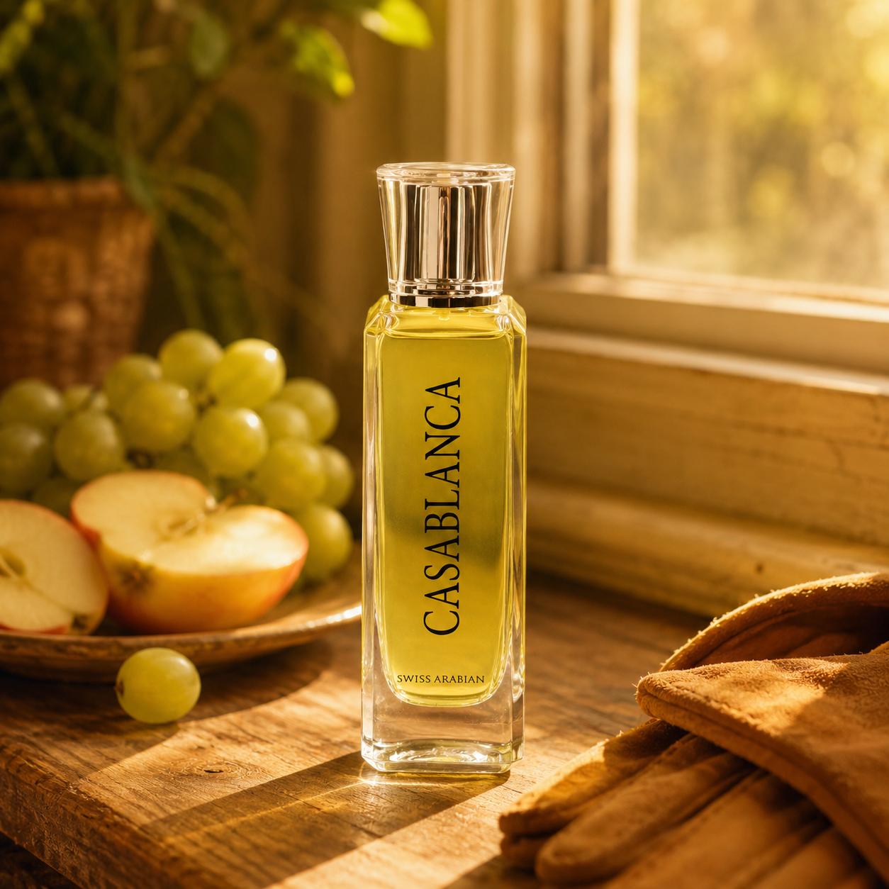 Swiss Arabian Casablanca perfume bottle styled with grapes and apple in a warm everyday setting